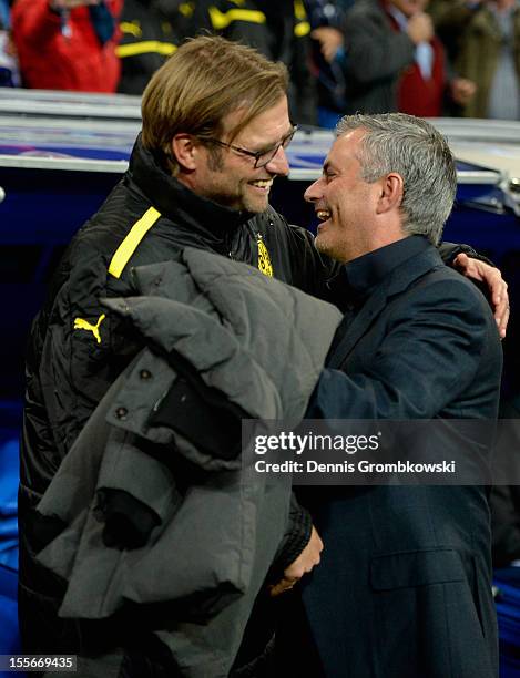 Head coaches Juergen Klopp of Dortmund and Jose Mourinho of Madrid hug prior to the UEFA Champions League Group D match between Real Madrid and...