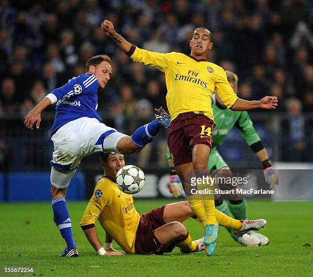 Theo Walcott of Arsenal goes past Shalke defender Benedikt Howedes to score his team's first goal during the UEFA Champions League Group B match...