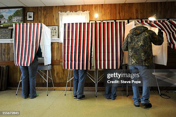 Voters cast their ballots at the WCR Hall November 6, 2012 in Macksburg, Iowa. As Americans go to vote, President Barack Obama and Republican nominee...