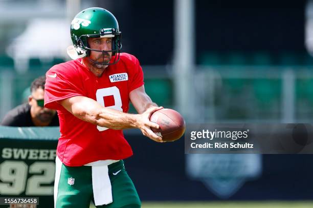 Quarterback Aaron Rodgers of the New York Jets looks to hand off during training camp at Atlantic Health Jets Training Center on July 26, 2023 in...