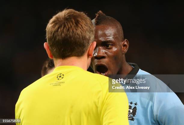 Mario Balotelli of Manchester City protests to Referee Peter Rasmussen after he denied him a penalty during the UEFA Champions League Group D match...