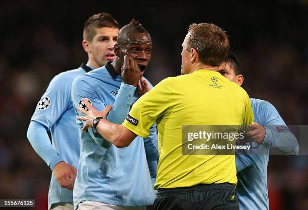 Mario Balotelli of Manchester City protests to Referee Peter Rasmussen after he denied him a penalty during the UEFA Champions League Group D match...