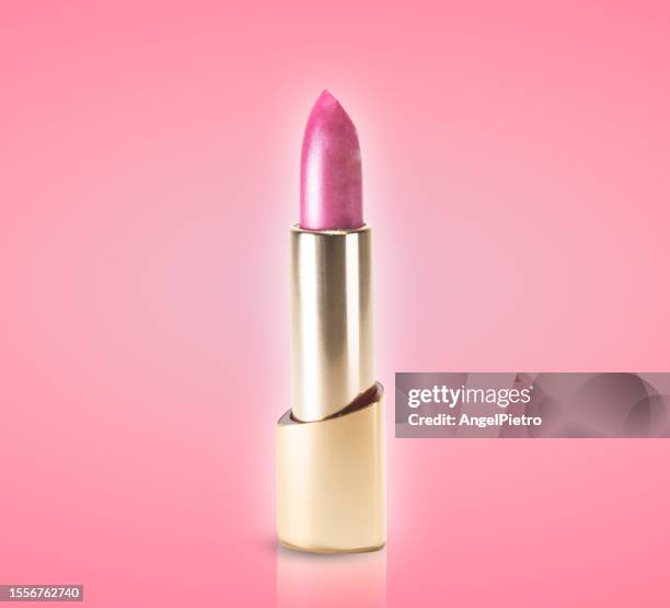 a pink lipstick on a background of the same color. - pink lipstick fotografías e imágenes de stock