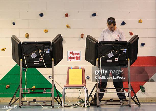 Voter casts his ballot November 6, 2012 in Minerva Park, Ohio. U.S. Citizens go to the polls today to vote in the election between Democratic...