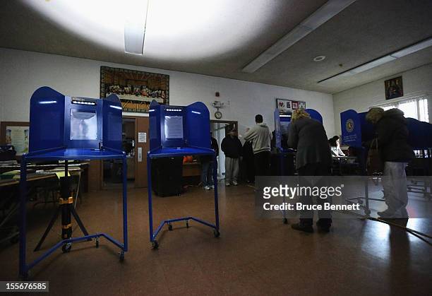 Displaced from their assigned polling location,voters mark their ballot at the generator powered First United Methodist Church on November 6, 2012 in...