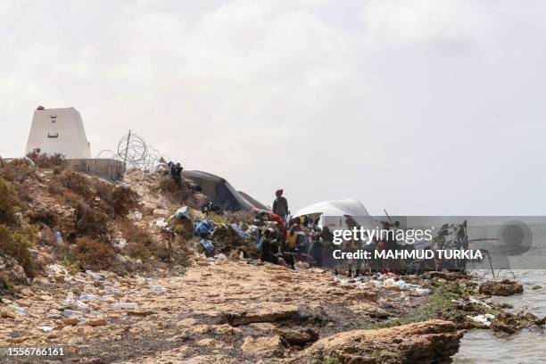 Migrants from Africa, stranded on the seashore at the Libyan-Tunisian border in Ras Jedir, stay on the rocky beach on July 26, 2023. African migrants...