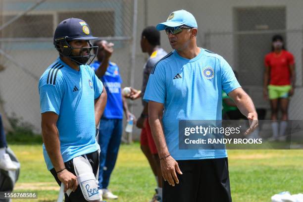 Rohit Sharma and Rahul Dravid , of India, take part in a training session one day before the first One Day International cricket match between West...