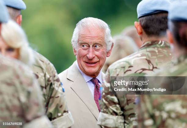 King Charles III talks with soldiers of the Army Air Corps as he visits the Sandringham Flower Show on the Sandringham estate on July 26, 2023 in...