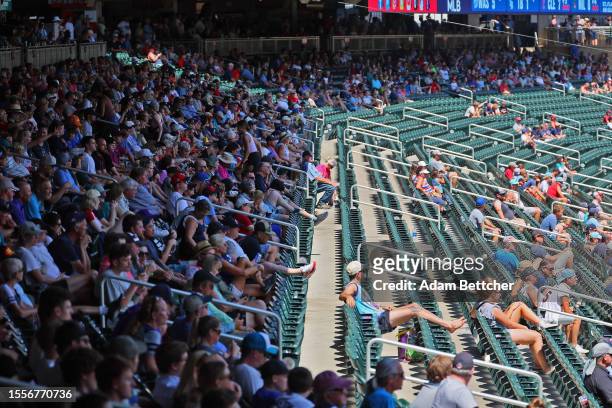 Fans seek the shade during the ninety-six-degree heat index game between the Minnesota Twins and the Seattle Mariners in the sixth inning at Target...