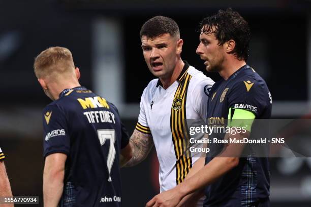 Dumbarton's Mark Durnan complains to Dundee's Scott Tiffoney accusing him of diving to win a penalty during a Viaplay Cup group stage match between...