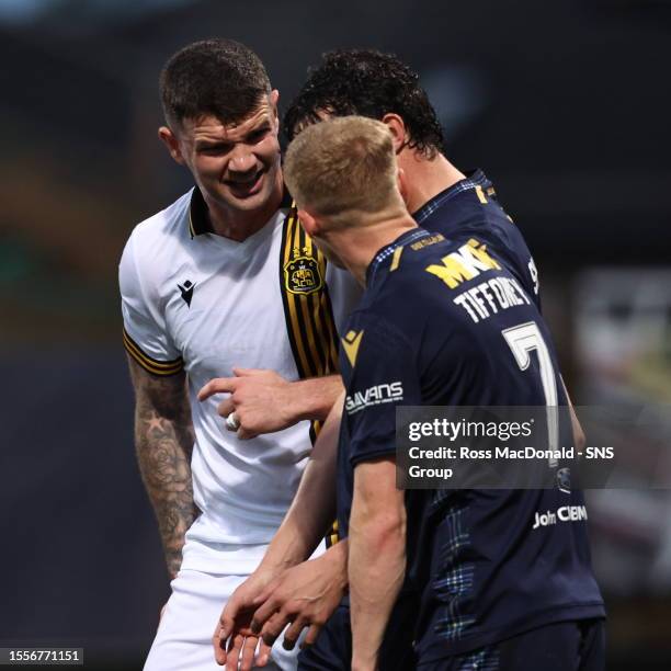 Dumbarton's Mark Durnan complains to Dundee's Scott Tiffoney accusing him of diving to win a penalty during a Viaplay Cup group stage match between...