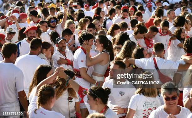 Couple embraces as people gather in front of the town hall during the opening ceremony of the 91th Bayonne festival in Bayonne, southwestern France,...