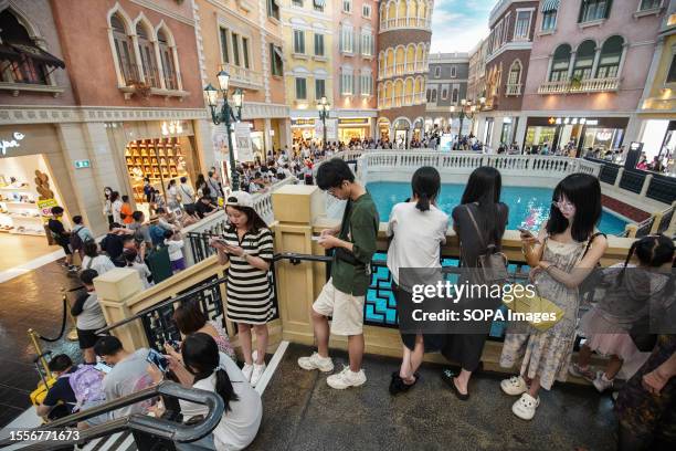 People wait to board on the boats inside The Venetian, one of the famous casino hotels in Macao Special Administrative Region.