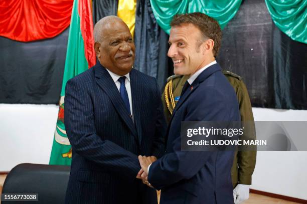 French President Emmanuel Macron shakes hands with Vanuatu's President Nikenike Vurobaravu at the President's residence in Port Vila, Vanuatu on July...