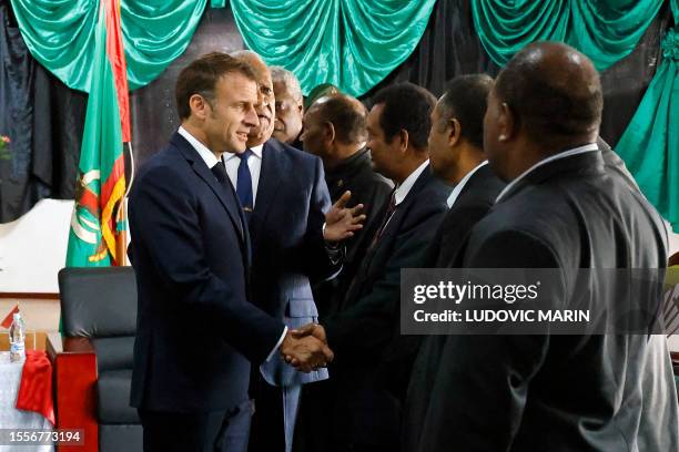 French President Emmanuel Macron , alongside Vanuatu's President Nikenike Vurobaravu , greets members of Vanuatu's government at the President's...