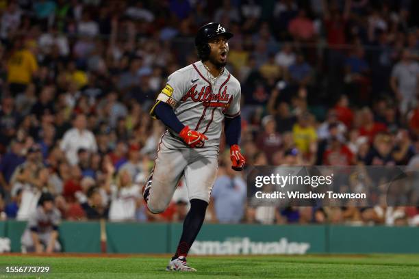 Ozzie Albies of the Atlanta Braves shouts while rounding the bases as he watches his three-run home run against the Boston Red Sox during the sixth...