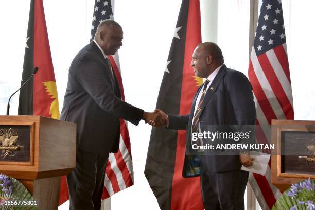 Papua New Guinea's Prime Minister James Marape shakes hands with US Secretary of Defense Lloyd Austin in Port Moresby on July 27, 2023.