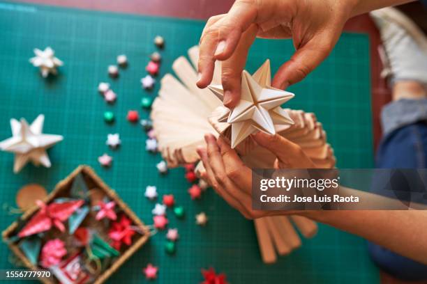 christmas composition with female hands, - origami tree stock pictures, royalty-free photos & images