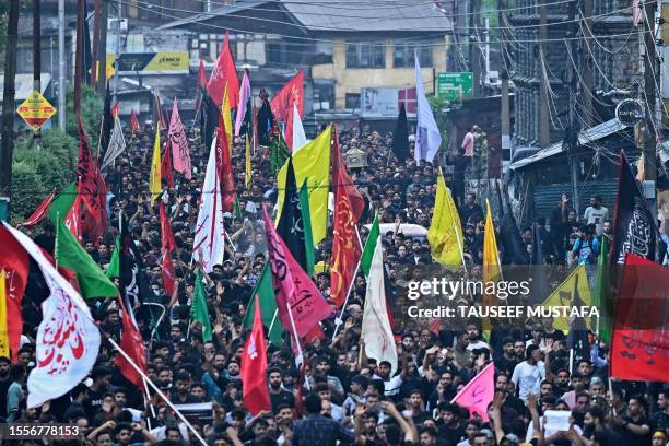 Kashmiri Shiite Muslim mourners take part in a Muharram procession on the eighth day of Ashura in Srinagar on July 27 after the state government...