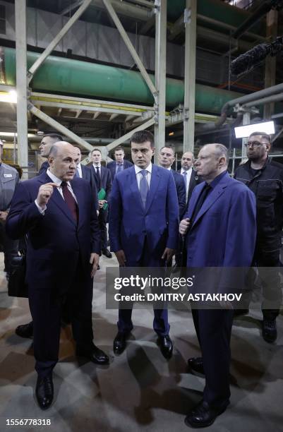 This pool image distributed by Sputnik agency shows Russian Prime Minister Mikhail Mishustin, accompanied by Krasnoyarsk Region Acting Governor...