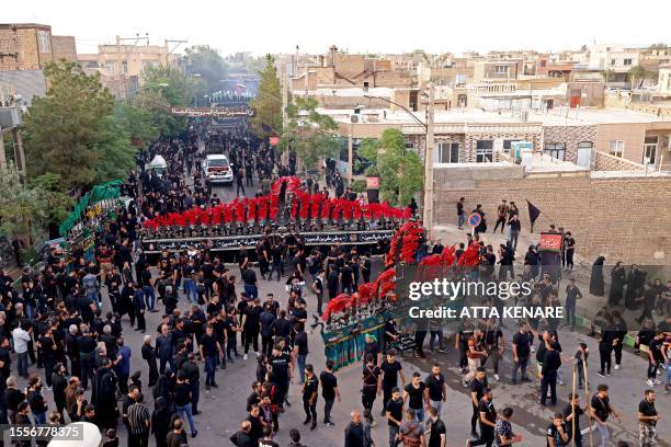 Shiite Muslims participate in a mourning ritual in the Iranian city of Noosh Abad on July 26 during the Muslim month of Muharram in the lead-up to...