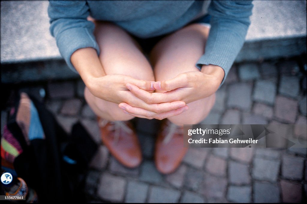 Woman sitting on steps in a park