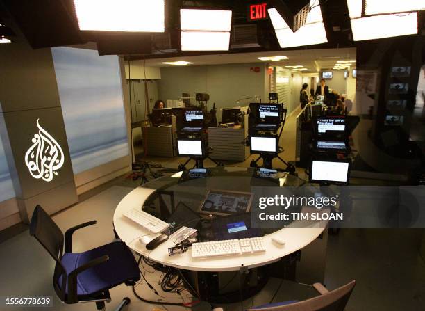 Colleagues work in the news room at al-Jazeera English studio headquarters 22 November 2006 in Washington, DC. Al-Jazeera English, a sister channel...