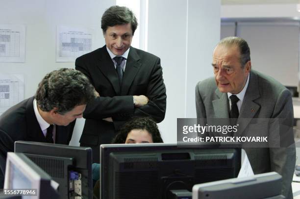 French President Jacques Chirac talks with the president of the new French-international news TV channel France 24, Alain de Pouzilhac and the...