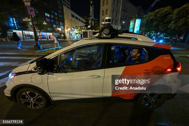 People travel with a Cruise, which is a driverless robot taxi, in San Francisco, California, USA on July 24, 2023. The self-driving service of...