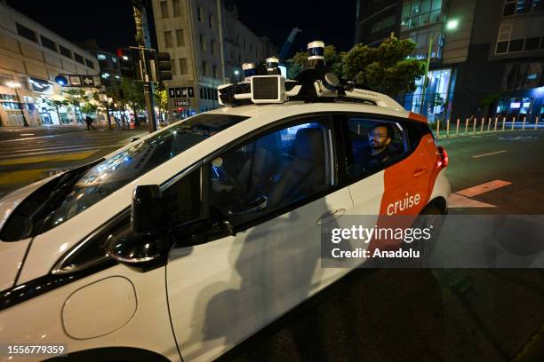 People travel with a Cruise, which is a driverless robot taxi, in San Francisco, California, USA on July 24, 2023. The self-driving service of...