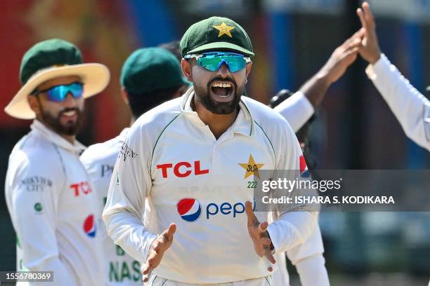 Pakistan's captain Babar Azam celebrates after taking the wicket of Sri Lanka's Dhananjaya de Silva during the fourth day of the second and final...