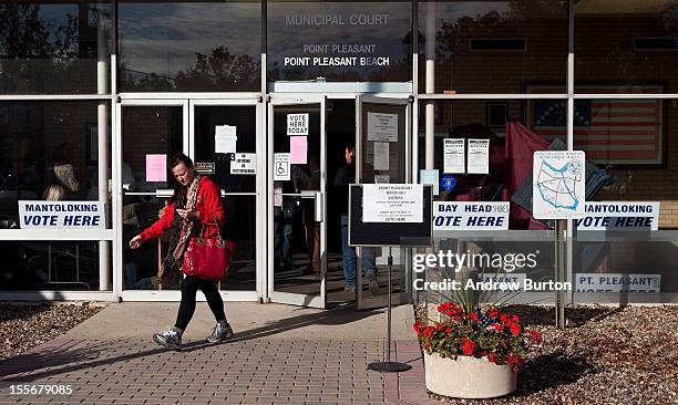 Woman leaves the Point Pleasant Municipal Building after voting in the presedential election on November 6, 2012 in Point Pleasant, New Jersey. As...