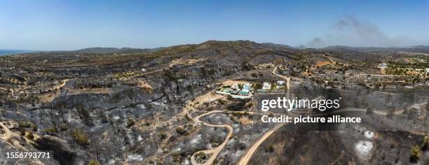 July 2023, Greece, Gennadi: Aerial photos from the village of Gennadi show the traces of the fire. But they also show the result of firefighting by...