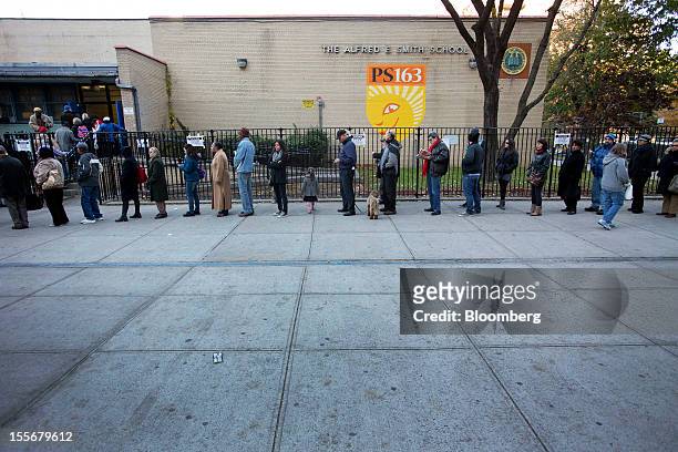 Voters wait in line to their cast ballots at PS 163 polling location in New York, U.S., on Tuesday, Nov. 6, 2012. U.S. President Obama is seeking to...