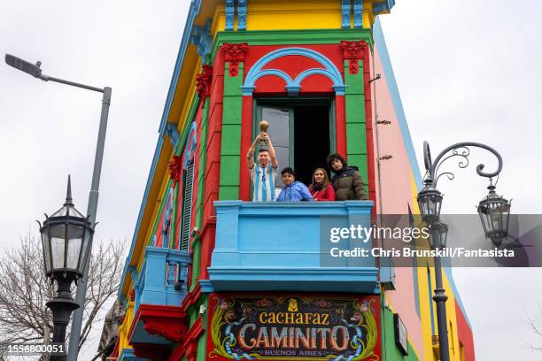 Tourists pose next to a life size model of Lionel Messi on July 19, 2023 in Buenos Aires, Argentina.