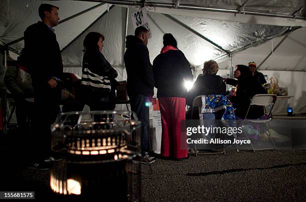 Portable heat lamp sits inside of a tent while people vote in the presidential elections in Midland Beach November 6, 2012 in the Staten Island...