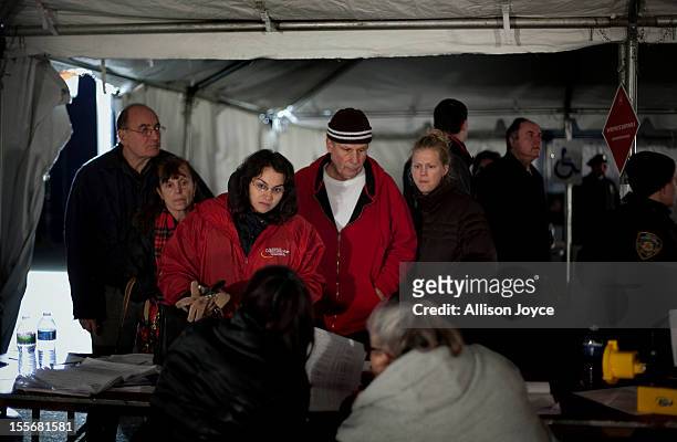 People wait to vote in the presidential elections in a tent in Midland Beach November 6, 2012 in the Staten Island borough of New York City. As...