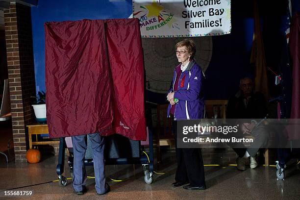 Man votes, by the light of generators, at Silver Bay Elementary School on November 6, 2012 in Toms River, United States. The Elementary school, which...