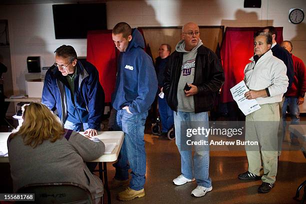 People wait in line, by the light of generators, to vote at Silver Bay Elementary School on November 6, 2012 in Toms River, United States. The...