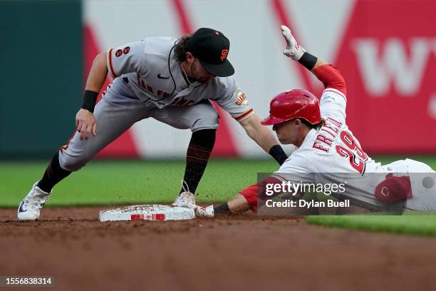 Friedl of the Cincinnati Reds reaches second base for a double past the tag by Brett Wisely of the San Francisco Giants in the third inning at Great...