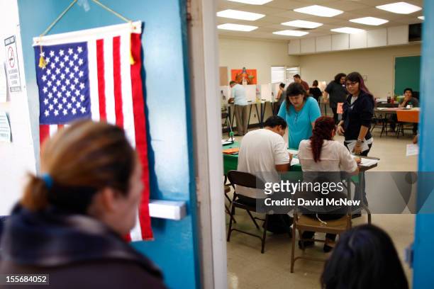 People vote at a polling place in the heavily Latino East L.A. Area during the U.S. Presidential election on November 6, 2012 in Los Angeles,...