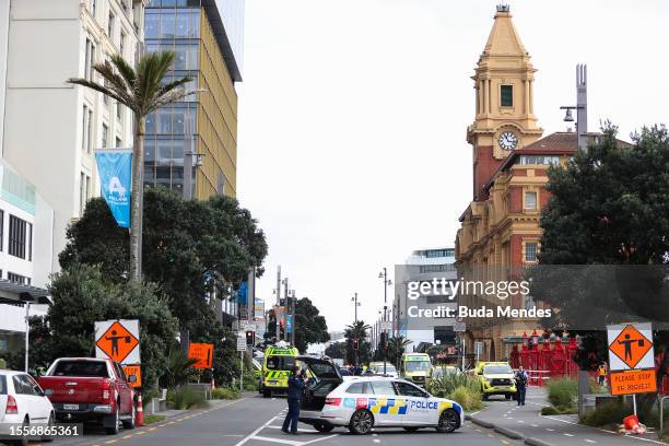 Police vehicles are seen near the location of a reported shooting on July 20, 2023 in Auckland, New Zealand. A gunman and two others others were...