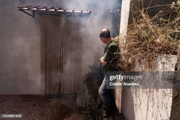 Man tries to put out the fire by himself in Cardeto, Reggio Calabria, Italy on July 25, 2023.