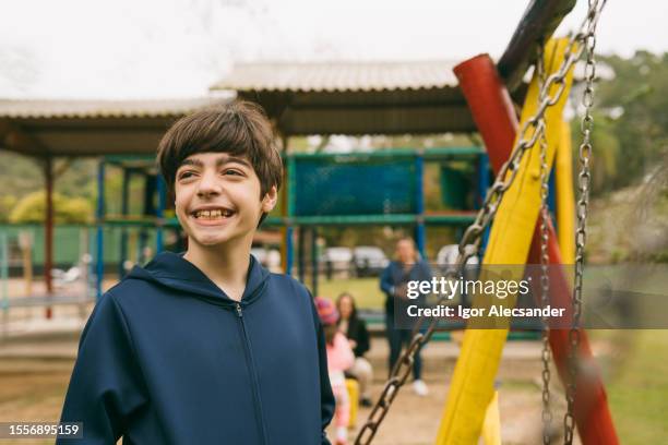 preteen boy smiling on playground - boy face happy stock pictures, royalty-free photos & images
