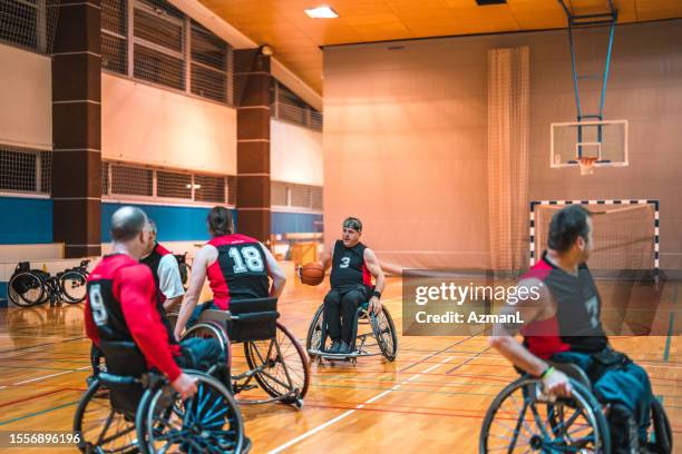 wheelchair basketball competitors rolling to control ball - hoop rolling stock pictures, royalty-free photos & images