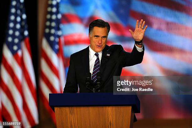 Republican presidential candidate, Mitt Romney, waves to the crowd while speaking at the podium as he concedes the presidency during Mitt Romney's...