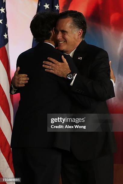 Republican presidential candidate, Mitt Romney, hugs Republican vice presidential candidate, U.S. Rep. Paul Ryan on stage after conceding the...