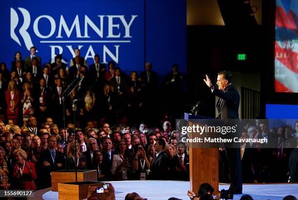 Republican presidential candidate, Mitt Romney, waves to the crowd while speaking at the podium as he concedes the presidency during Mitt Romney's...