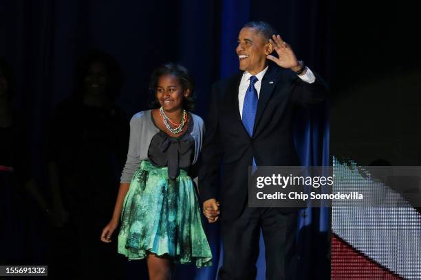 President Barack Obama walks on stage with daughter Sasha to deliver his victory speech on election night at McCormick Place November 6, 2012 in...