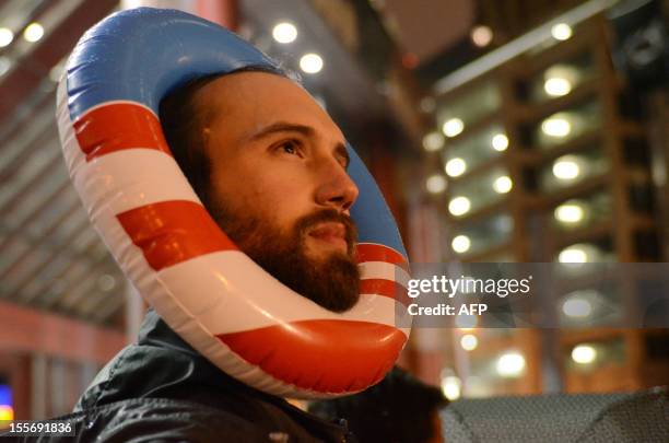 Man watches results of the US presidential elections at US President Barack Obama's election night event in Chicago on November 6, 2012. Obama swept...